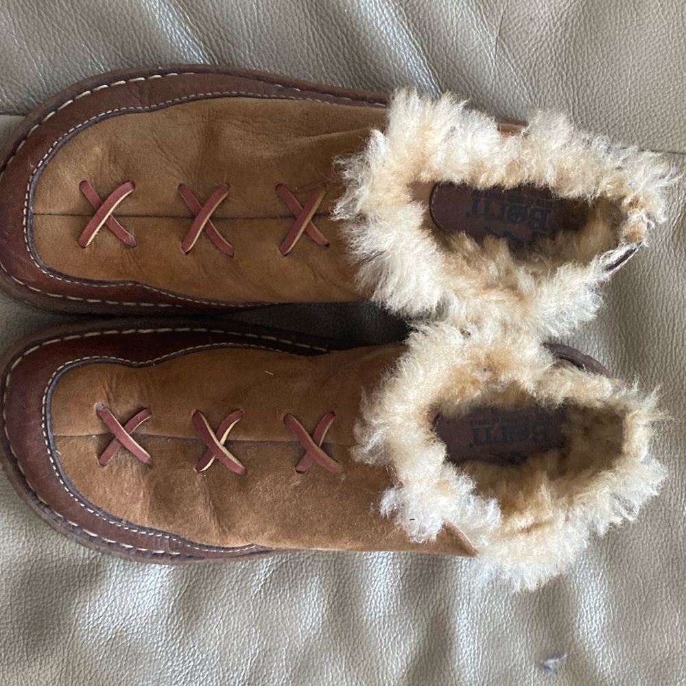 Born suede and leather slip on shoes with simulated fur inside.